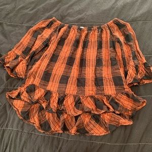 Black and Brown plaid shirt. Loose fitting. Ruffled neckline and sleeves